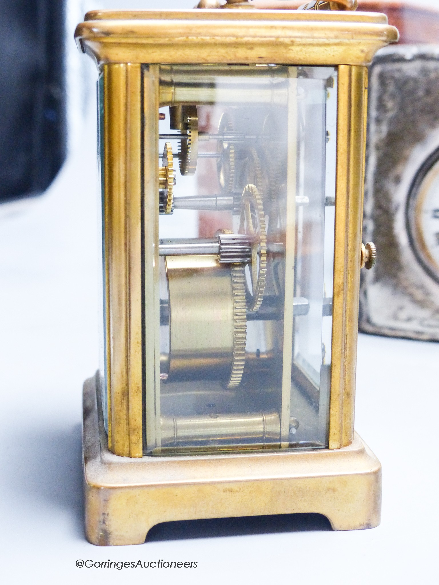 A cased carriage clock and a silver mounted motorwatch